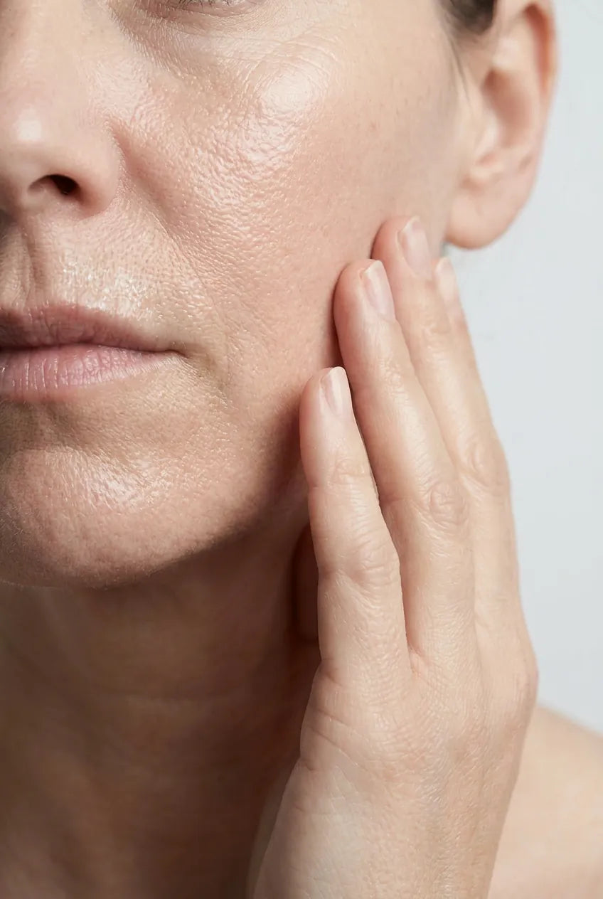 Close-up of mature skin along the jaw and cheek, untouched texture
